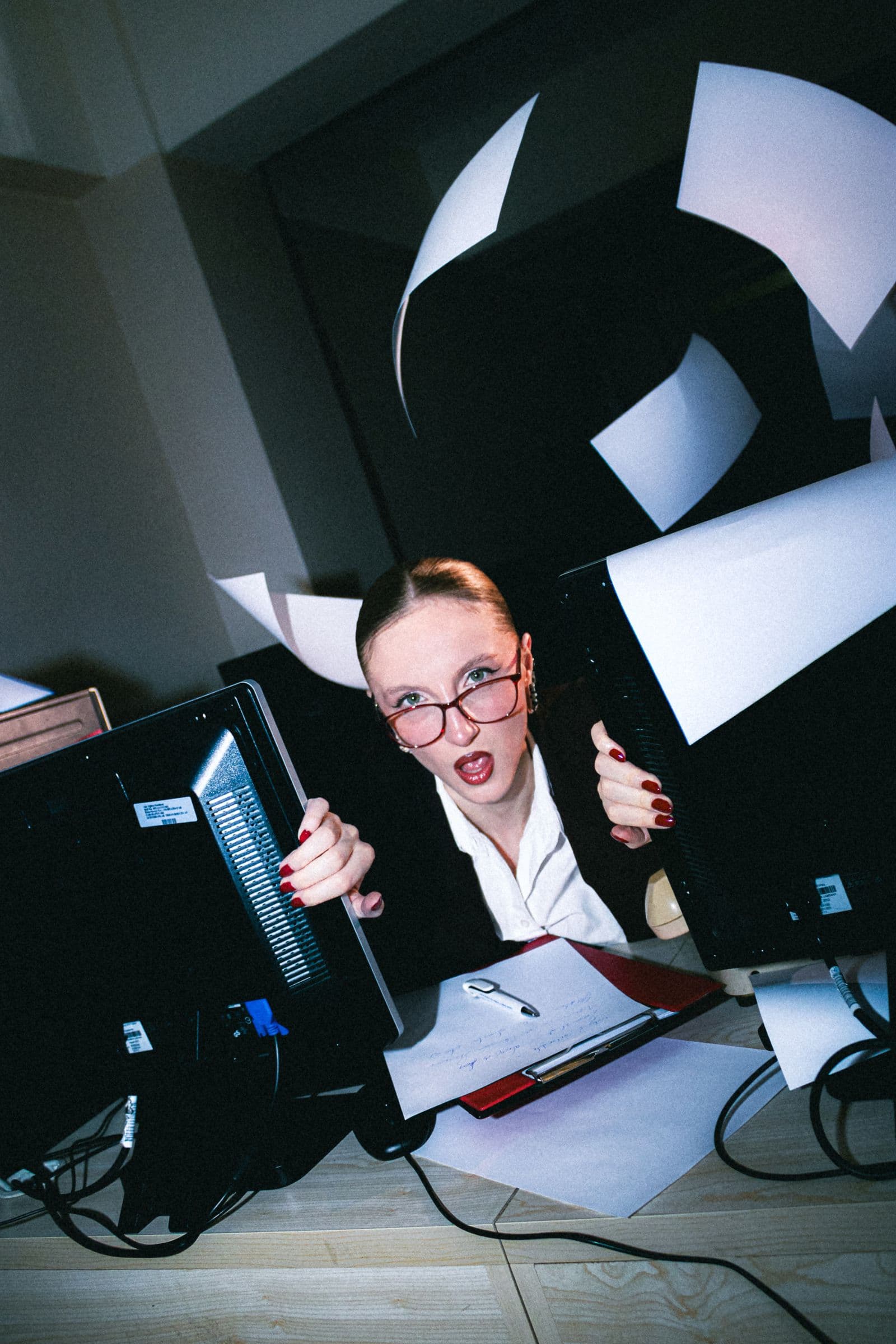 Overwhelmed business owner surrounded by paperwork