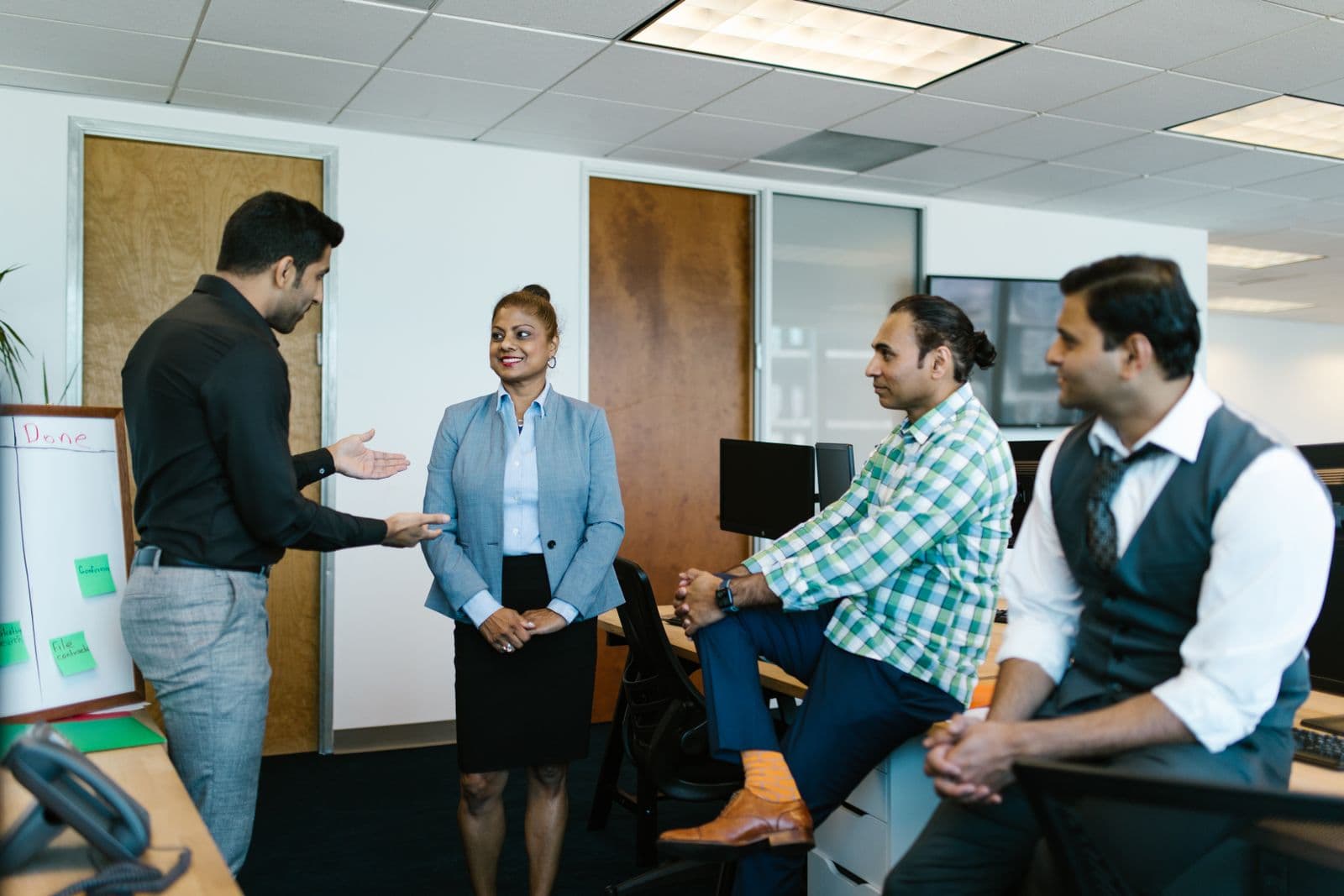 Colleagues talking through a problem together in person